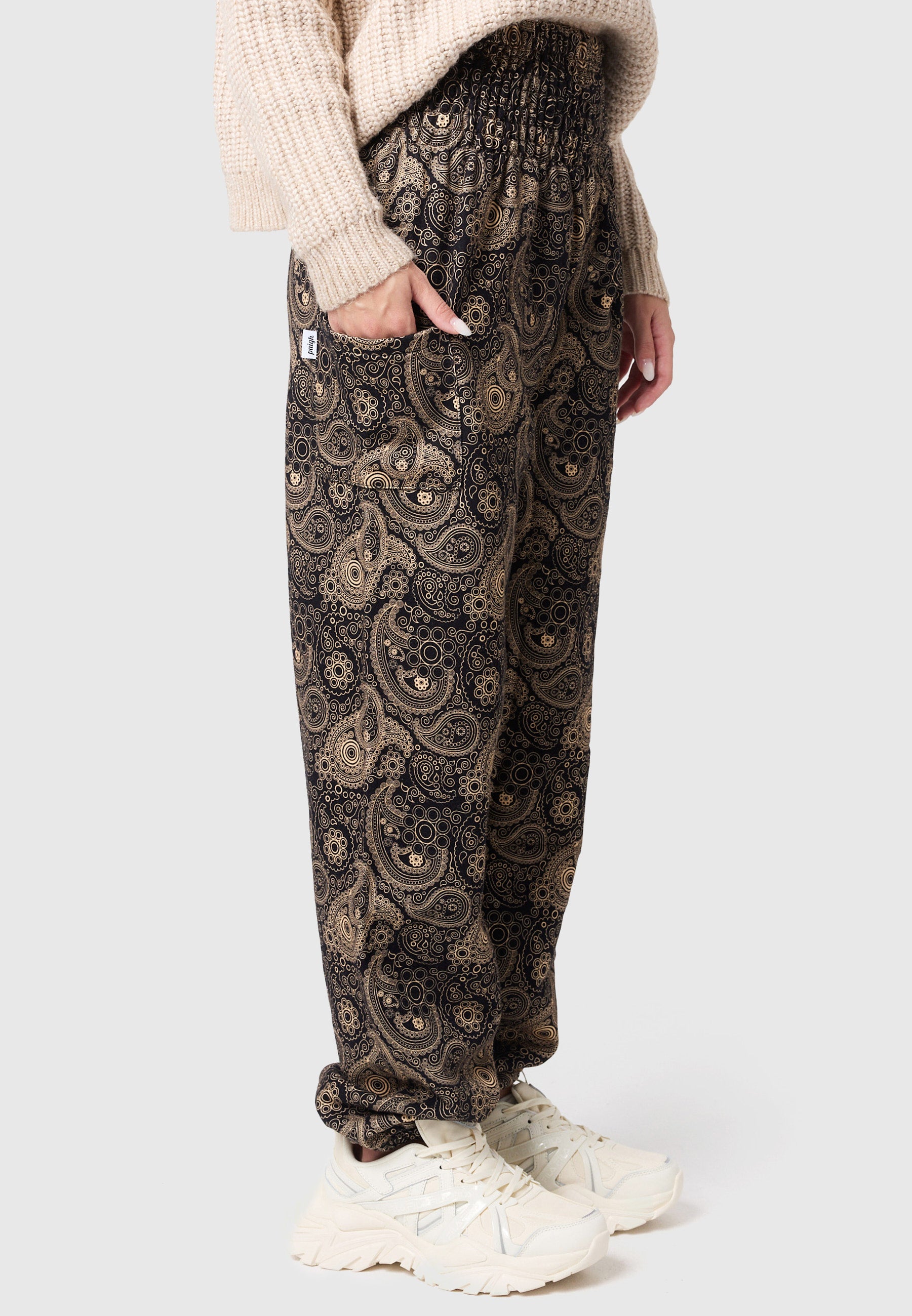 Pantalones bombachos cálidos con adornos dorados