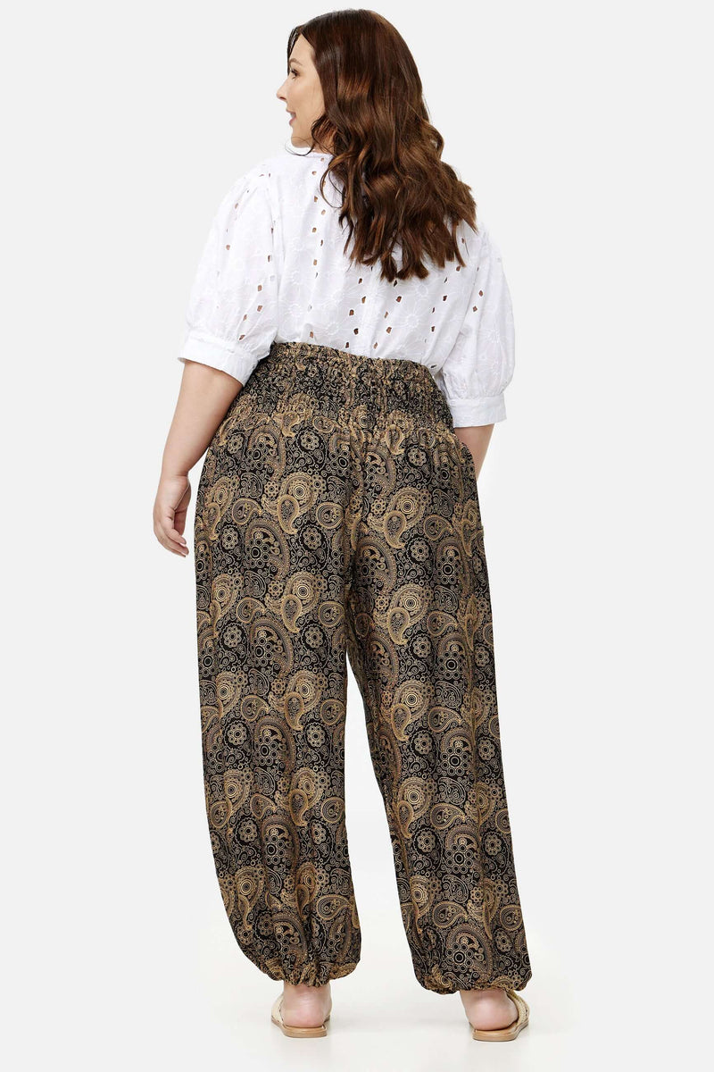 Frau in schwarz-goldener Haremshose Goldene Ornamente Plus Size von hinten